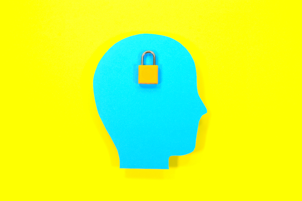 Concept of knowledge, data and protection. Paper human head with pad lock.